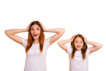 Portrait of impressed mom with her daughter having long haircut touching their head screaming wow omg isolated over yellow background