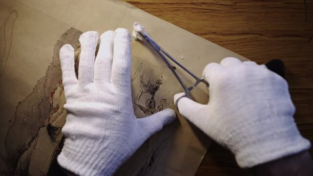 Antique fine art restorer cleans picture with acetone chemical swab CLOSE-UP