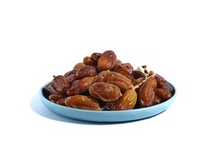 Pile of sweet dates on blue plate isolated on white background. Dried date fruit or dates, ramadan food