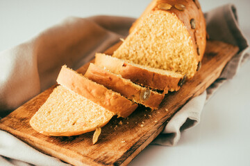 Pumpkin and carrot bread on wooden board on white background