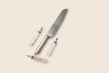 syringe knife photo studio shot on flat background
