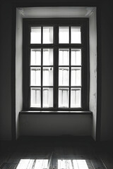 Fototapeta premium Black and white image of a window with multiple panes, casting light on a wooden floor, creating a serene atmosphere