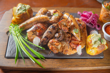 Deep fried battered snacks for beer on a wooden tray on the table