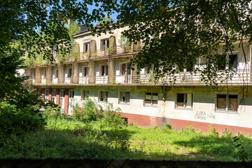 Abandoned old building of hospital sanatorium. House with broken windows and balconies home....