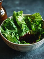 A refreshing green salad in a bowl, drizzled with dressing.