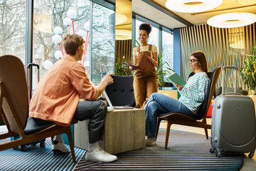 Colleagues collaborating in a vibrant hotel lobby during a business trip