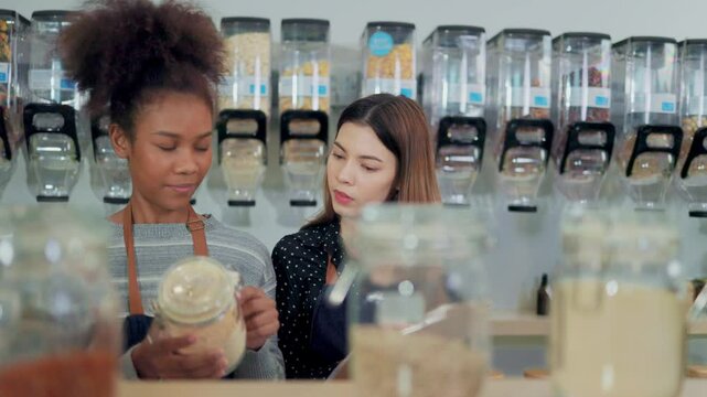Young Woman Owner in Apron Selling Superfoods in Zero Waste Shop.  No plastic Conscious Minimalism Vegan  sustainable plastic free Lifestyle Concept.