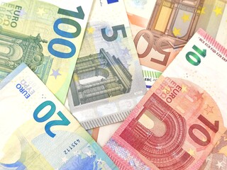 Background view featuring an array of Euro banknotes in various denominations, conceptual image.