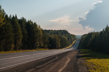 An empty road in the mountains at sunset