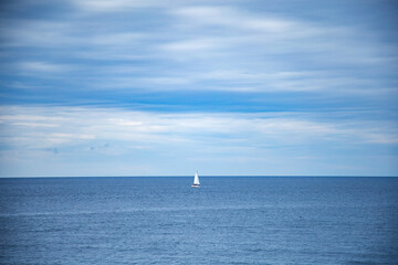 Fototapeta premium Yacht in the sea. Sailing boat on the sea. Sailboat on the sea. Horizon. Sea and blue sky