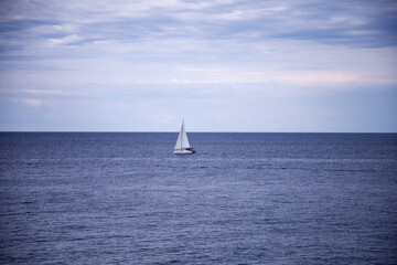 Fototapeta premium Yacht in the sea. Sailing boat on the sea. Sailboat on the sea. Horizon. Sea and blue sky