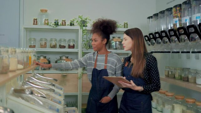 Young Woman Owner in Apron Selling Superfoods in Zero Waste Shop.  No plastic Conscious Minimalism Vegan  sustainable plastic free Lifestyle Concept.