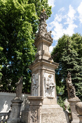 Obraz premium The statue of St John of Nepomuk stands near the fence of Ossuary Kostnice Sedlec chapel in Kutna Hora in the Czech Republic