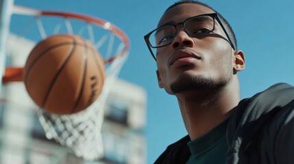 Myopia prevention with a man wearing glasses playing basketball outdoors. Wellness, fitness, and eye protection