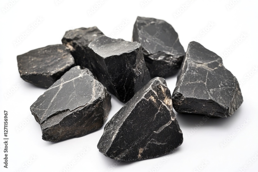 Aufkleber a pile of black rocks arranged on a white surface, great for use in still life compositions or as a 