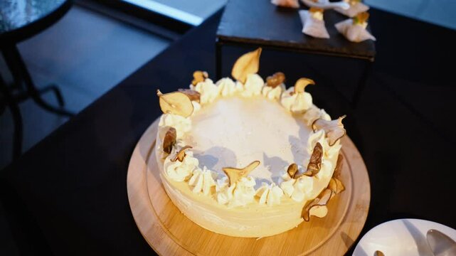 sweet delicious beautiful cream cake with dried fruits at the party. Gender party in honor of the birth of a baby boy or girl