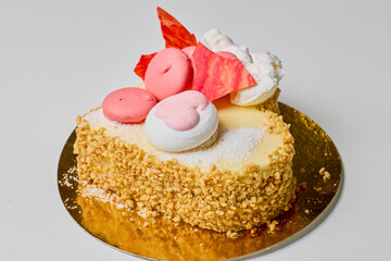 a mini heart-shaped cake with macarons and hazelnuts