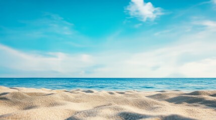 Obraz premium A serene beach scene with golden sand, a calm blue sea, and a clear sky, perfect for relaxation and tranquility.