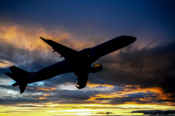 Airplane at sunset. A passenger plane takes off against the backdrop of a sunset. Commercial...