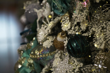 Festive Christmas Tree Decorated with Ornaments, Lights, and Tinsel in a Winter Wonderland Setting