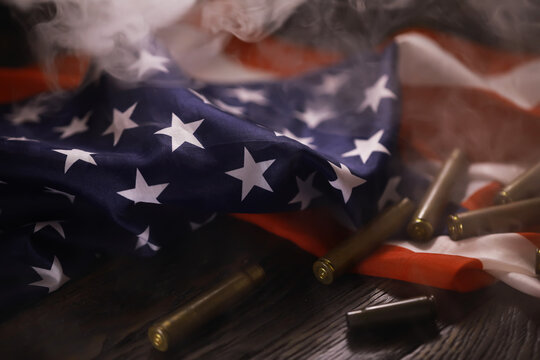 American Flag with Bullet Casings and Smoke: Symbol of Conflict and Patriotism