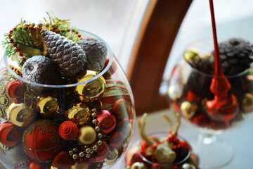 Festive Christmas Decorations in Glass Containers with Pine Cones and Ornaments