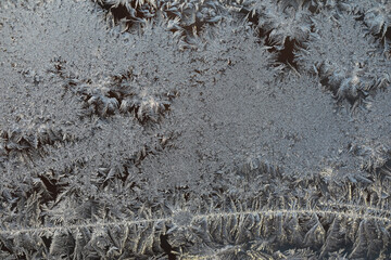 Close-Up of Detailed Frost Patterns on Glass Capturing Winter's Intricate Beauty