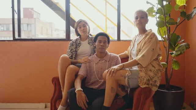 Group of friends bonding at home, LGBTQ and diversity concepts - Homosexual couple and fluid gender non binary young man with cross dressing clothing style having fun in the apartment, LGBT people