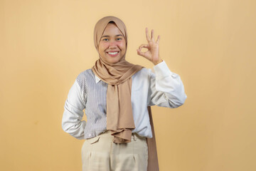 Happy Muslim Woman in Hijab Showing OK Hand Gesture
