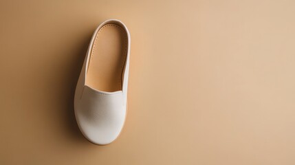 White Leather Slip-on Shoe on a Beige Background