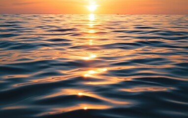 Obraz premium Peaceful sunset over a calm sea with gentle ripples
