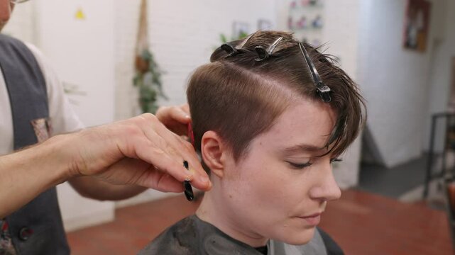 Hairdresser preparing hair for cutting in slow motion