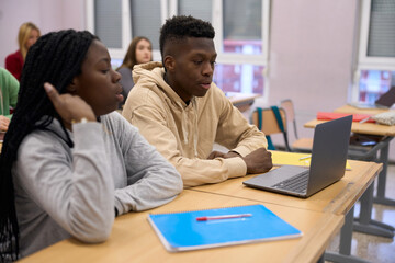 Students using laptop during class at university or high school