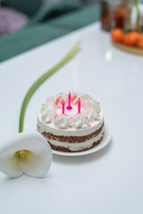 Birthday cake with pink candles. Cheesecake with raspberries