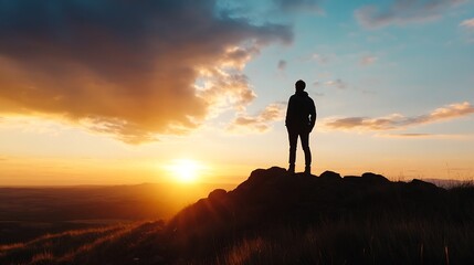 Silhouette of a Person Standing on a Rock at Sunset Against a Dramatic Sky : Generative AI