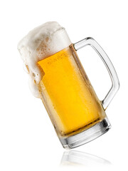 Cold lager beer mug with foam overflowing on white background, studio shot