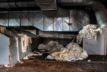 old abandoned industrial textile machinery with cotton waste
