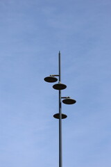 street lamp against blue sky