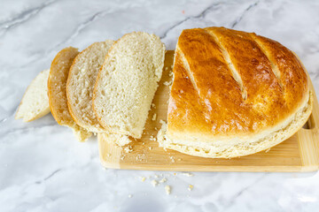 Freshly baked bread on a cutting board.
