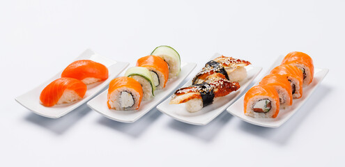 Assorted sushi and maki rolls beautifully arranged on plates © evgeeenius