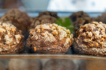 A closeup of freshly baked large round wholewheat bread on a tray 