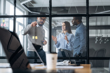 Fototapeta premium Tactics, planning the job. Professional workers are in the modern office together