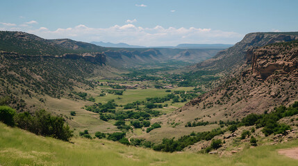 Naklejka premium Serene Valley Vista of a Rural Community in a Mountain Landscape on a Sunny Day with Blue Sky
