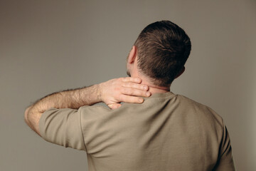 man suffers from back pain due to negative impact of long work at computer, bad posture,...