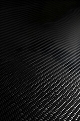 Abstract close-up of textured black surface with wavy patterns and subtle reflections