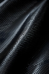 Close-up of textured black fabric showcasing intricate patterns and light reflections (1)