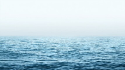 Fototapeta premium The peaceful blue sea, with light waves and a clear horizon, leaving plenty of empty space for design or text.