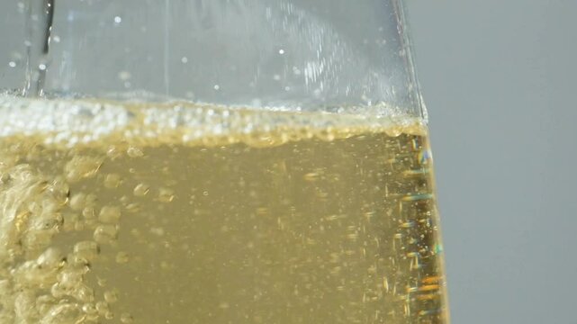 Wine white vinegar is poured, slow motion macro, lots of bubbles in liquid