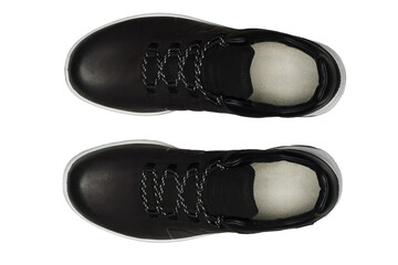 Stylish black leather sneakers with white soles and gray laces, shown from above. Isolated on transparent background