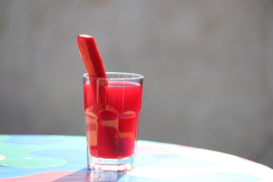 Fermented black carrot juice (known as shalgam or şalgam) with carrot pieces in a glass